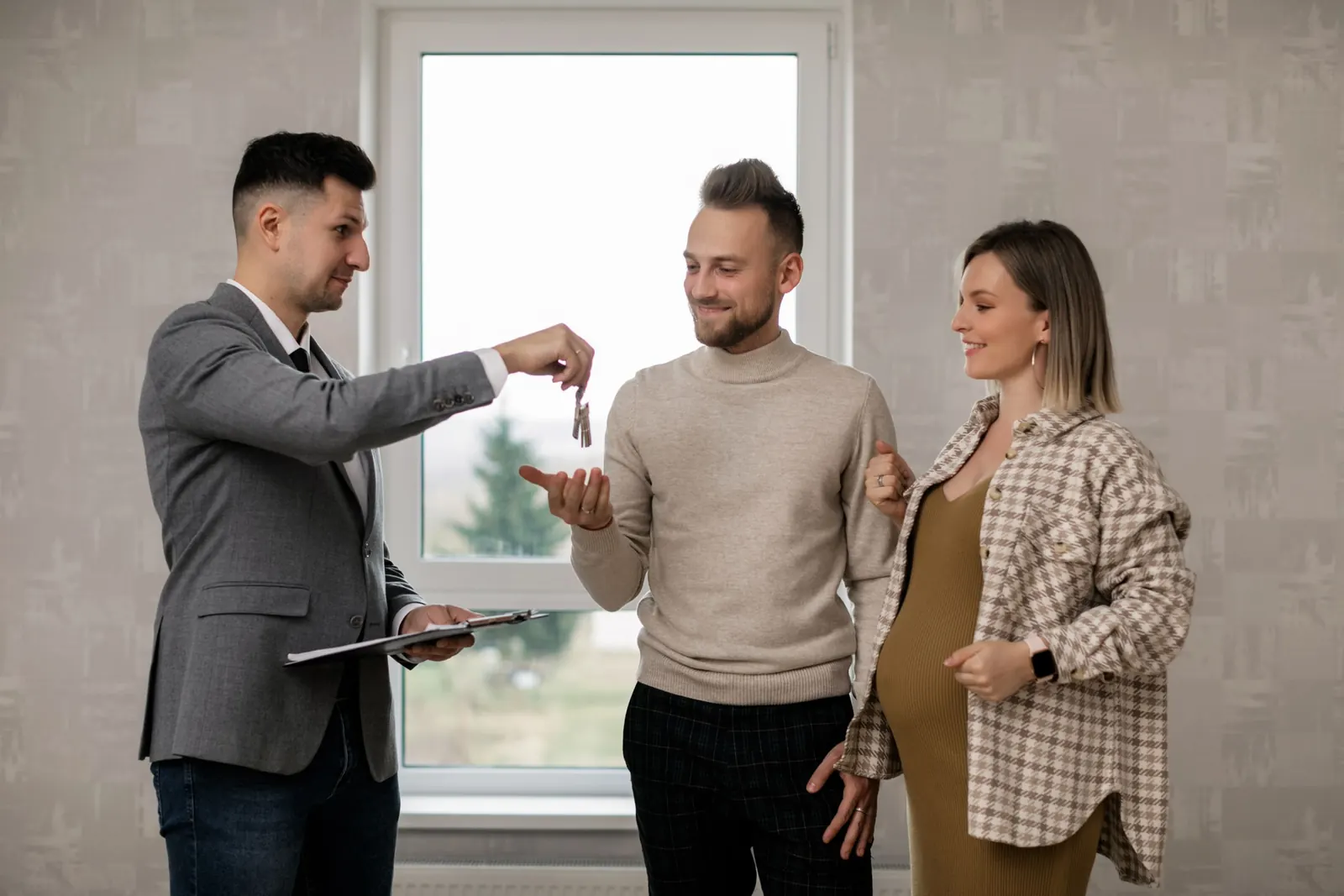 A hand holding house keys
